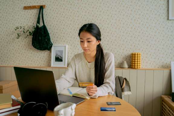 Woman on computer using credit card