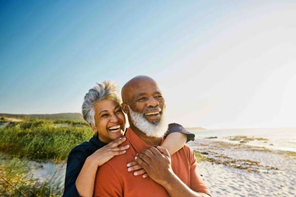 Active Mature African-American Couple Enjoying Retirement and Each Other’s Company at the Beach.