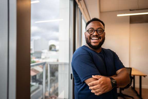 man crossing arms smiling