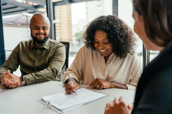 Women signing paper