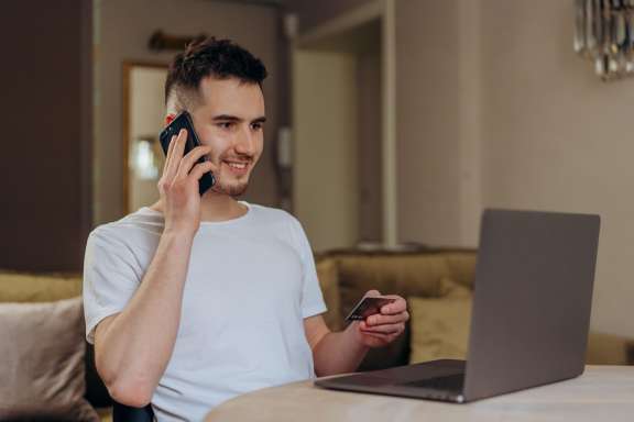 Man on phone with card