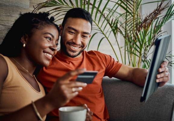 Couple looking at ipad and card