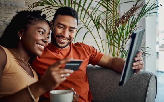 Couple looking at ipad with card