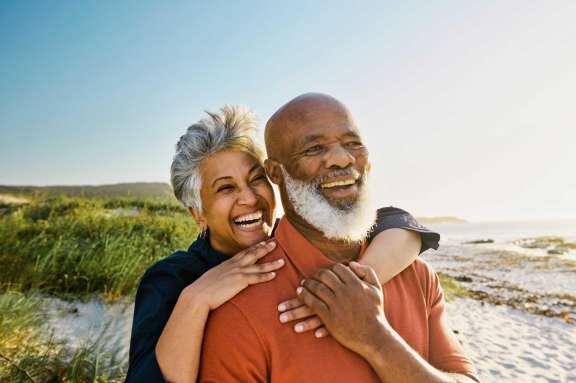 elderly couple smiling outside