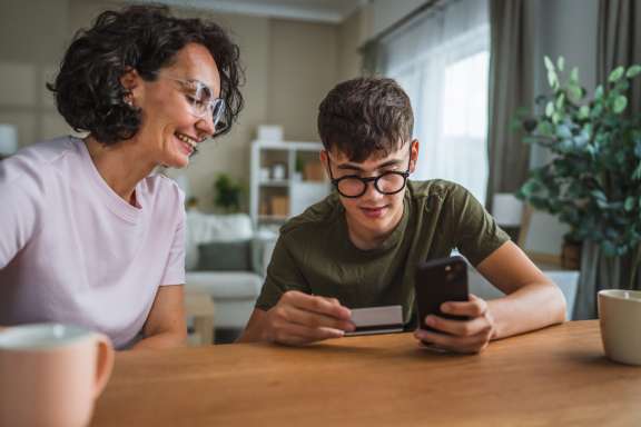 mom and kid looking at phone