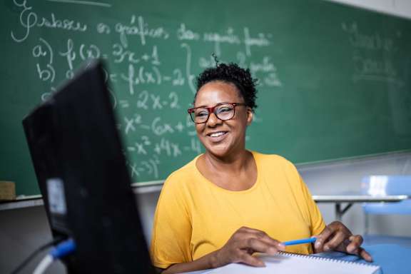 Teacher in front of blackboard