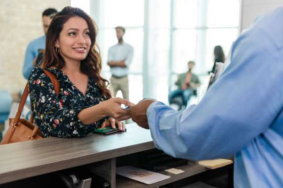 Woman handing over card