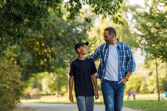 Kid walking with dad