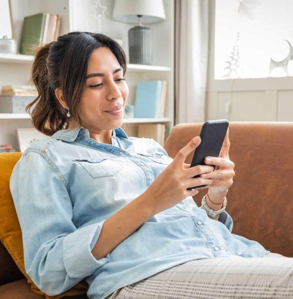 Woman looking at phone on couch 2026 07 16 183434 acop