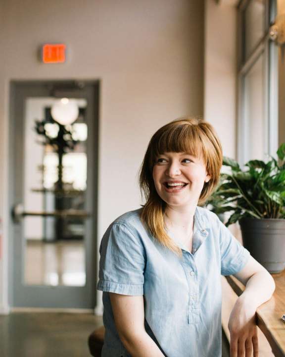 Woman looking sideways smiling cropped