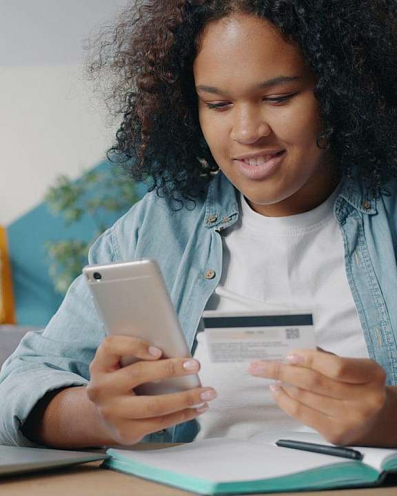 Woman making online purchase with credit card cropped